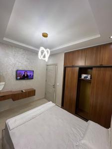 a bedroom with a bed and a tv on the wall at Résidence Saadia, Khouribga in Khouribga