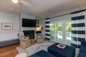 a living room with a fireplace and a tv at Miss Irene in Edisto Island