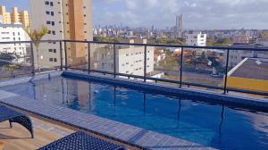 a large swimming pool on top of a building at Flat com piscina na cobertura em Intermares in Cabedelo