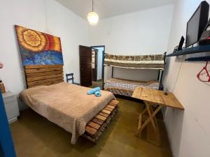 a bedroom with two bunk beds and a desk at Renacer en Salta in Salta