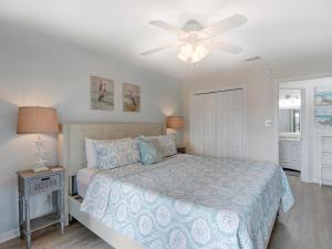 a bedroom with a bed and a ceiling fan at Sweet Location with Sophistication in Tybee Island +26 photos