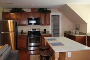 a kitchen with wooden cabinets and a stove top oven at Palmetto Hut in Edisto Island
