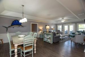 a dining room and living room with a dining table at Sutton House in Edisto Island