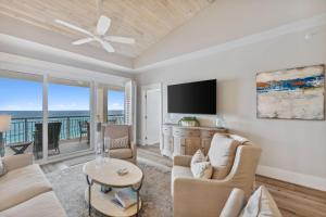 a living room with a couch and a tv at HP 45W What the Heck by 30A Escapes in Rosemary Beach +28 photos