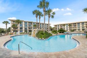 a swimming pool with palm trees in a resort at HP 45W What the Heck by 30A Escapes in Rosemary Beach