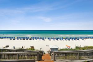 a view of a beach with chairs and the ocean at HP 422 Blue Haven by 30A Escapes in Rosemary Beach