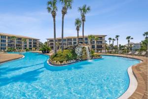 a swimming pool at a resort with palm trees at HP 422 Blue Haven by 30A Escapes in Rosemary Beach
