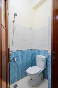 a bathroom with a toilet and blue tiles at RESIDENCE Al SALAM in Tangier