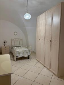 a bedroom with a bed and a dresser at Amber house in Lesina