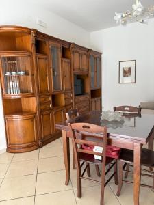a dining room with a table and wooden cabinets at Amber house in Lesina