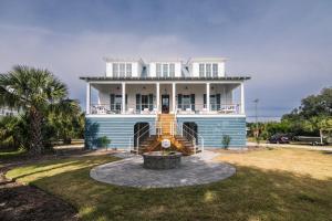 a large white house with a staircase in front of it at Glory Be in Edisto Island