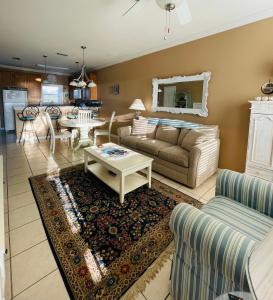 a living room with a couch and a table at 123 Beau Clair - Beachside Townhome with Balcony and Pool in Long Beach in Long Beach