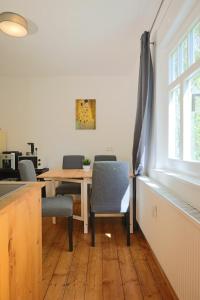 a dining room with a table and chairs and a window at Gemütliches Schmuckstück mit zwei Schlafzimmern in Mügeln