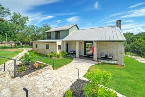 a house with a stone patio and a yard at Waterfront Sleeps 16 Perfect for Family & Wurstfest in McQueeney