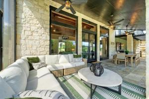 a living room with a white couch and a table at Waterfront Sleeps 16 Perfect for Family & Wurstfest in McQueeney +38 photos