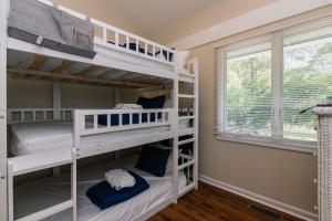 two bunk beds in a room with a window at 493 Egrets Pointe - Dove's Nest in Edisto Island +27 photos
