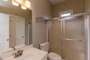 a bathroom with a shower and a sink and a toilet at Tequila Sunset in Edisto Island +88 photos