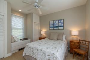 a bedroom with a bed and a ceiling fan at Tequila Sunset in Edisto Island