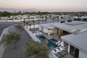 an aerial view of a building with a swimming pool at Krypton @ Elemento49 Pool Spa Sleeps 16 in Desert Groves Mobile Home Park