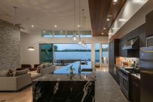 a kitchen and living room with a view of the ocean at Carbon @ Elemento49 Pool Spa Sleeps 16 in Desert Groves Mobile Home Park