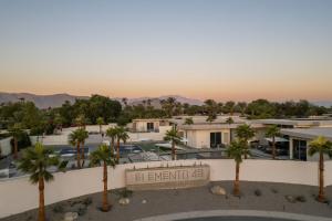 an aerial view of the resort with palm trees at Carbon @ Elemento49 Pool Spa Sleeps 16 in Desert Groves Mobile Home Park