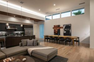 a living room with a couch and a table at Oxygen @ Elemento49 Pool Spa Sleeps 16 in Desert Groves Mobile Home Park