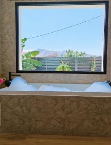 Villa Cora Murcia , Oasis De Relax في Los López: نافذة كبيرة في غرفة مع حوض استحمام