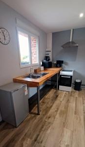 a kitchen with a sink and a wooden counter top at Nature et Moi in Wittes +6 photos