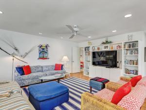 a living room with a couch and a tv at Coops Retreat Unit A in Tybee Island