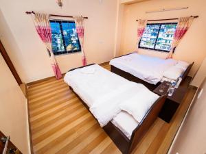 Katil atau katil-katil dalam bilik di Hotel Sunflower