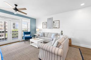 a living room with two couches and a ceiling fan at Hidden Gem #6 by 30A Escapes in Seacrest