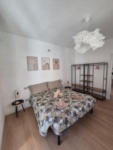 a bedroom with a bed and a chandelier at Il Glicine Bianco in Omegna