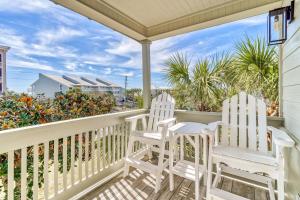 two chairs on a porch with a view of the ocean at Happy Hour on 30A #5 by 30A Escapes in Seacrest