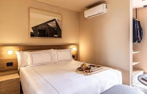 a bedroom with a large white bed with a mirror at Kukun Edition Marsella Juarez in Mexico City +42 photos