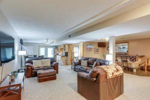 a living room with leather furniture and a kitchen at Work and Relax! Spacious Ontario Home with Pool in Mansfield