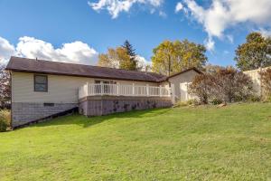 a house with a large yard in front of it at Work and Relax! Spacious Ontario Home with Pool in Mansfield