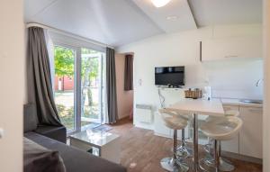 a living room with a couch and a table and a kitchen at 2 Bedroom Cozy Stacaravan In Obrovac in Obrovac