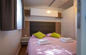a bedroom with a bed with two towels on it at 2 Bedroom Cozy Stacaravan In Obrovac in Obrovac