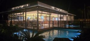 a building with a pool in front of it at night at Mandacaru Encantado in Miguel Pereira