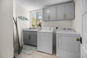 a kitchen with white appliances and a window at Lemon Bay Luxe – Dock, Beach & Manasota Vibes in Punta Gorda Beach +42 photos