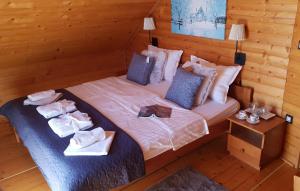 a bedroom with a bed with towels on it at Pet Friendly Home In Gornje Dubrave With Sauna in Perići