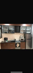 a kitchen with a stove and a refrigerator at Aquaview in Bijilo +3 photos