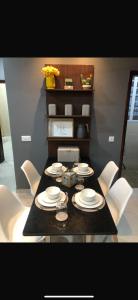 a dining room table with white dishes on it at Aquaview in Bijilo