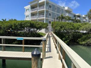 a building on a boardwalk over a body of water at Manasota Key Gem - Pool and Hot Tub - Beach Views in Punta Gorda Beach