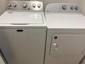 a white stove and a refrigerator in a kitchen at Manasota Key Gem - Pool and Hot Tub - Beach Views in Punta Gorda Beach