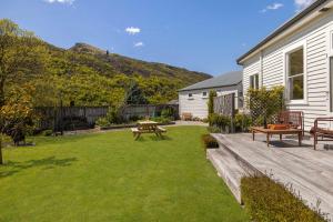 a backyard with a picnic table and a bench at The 1909 Gables Villa in Arrowtown +31 photos