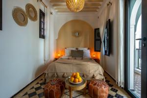 a bedroom with a bed and a table with fruit on it at Riad NL&S Collection in Marrakech