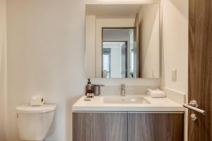ein Badezimmer mit Waschbecken, Toilette und Spiegel in der Unterkunft Nido at Gran Ciudad Nuevo Polanco in Mexiko-Stadt + 97 Fotos