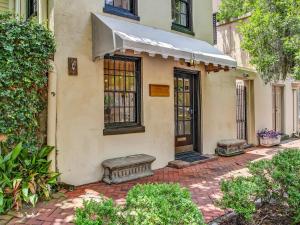 a house with two benches in front of it at Courtyard Off Madison Square in Savannah
