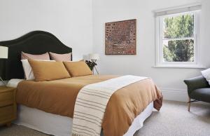 a bedroom with a large bed and a window at Bendigo Signature Accommodation Wattle Street in Bendigo